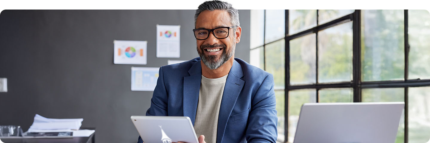 Man sitting in office reviewing business plan.