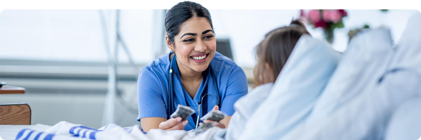 Nurse smiling with young patient.