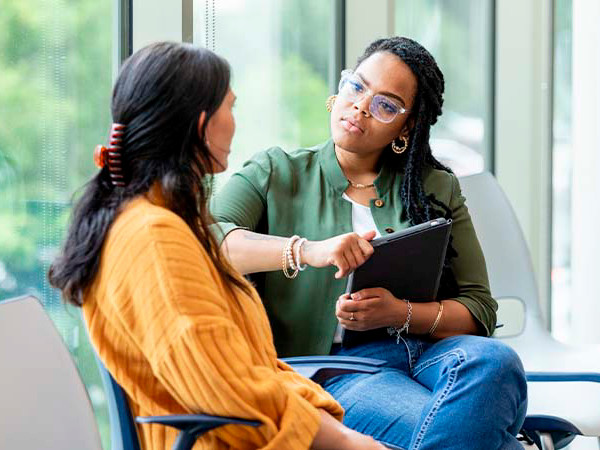 Two Women Discussing Trauma-Informed Approaches