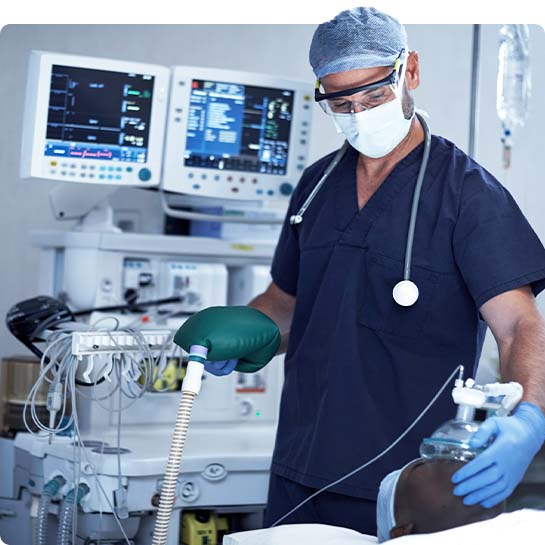 Nurse helping a patient who is laying in a bed in a hospital room