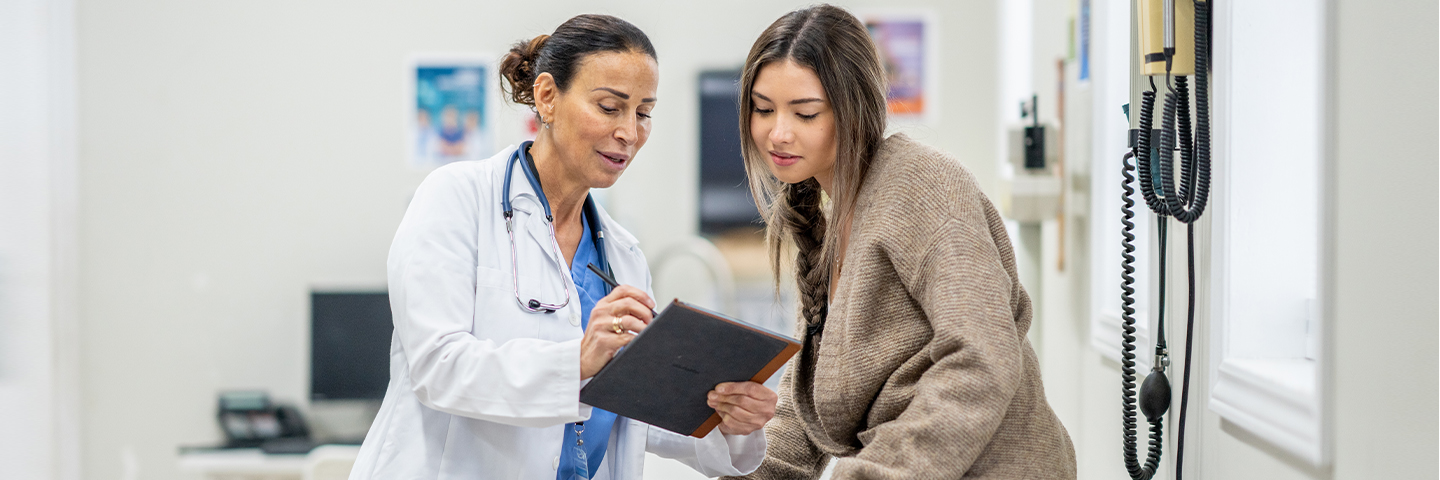 Nursing student showing a patient a document