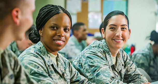 Military students discussing class at a table.